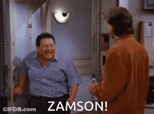 Two Men Are Standing In Front Of A Door And One Of Them Is Laughing And The Other Is Saying Zamson GIF
