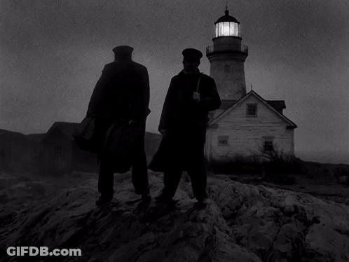 Two Men Are Standing In Front Of A Lighthouse GIF