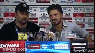 Two Men Are Standing In Front Of A Nova Sports Sign GIF
