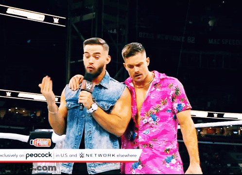 Two Men Are Standing In Front Of A Peacock Logo GIF