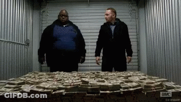 Two Men Are Standing In Front Of A Pile Of Money With A Sign That Says ' A & M ' On It GIF