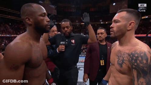 Two Men Are Standing In Front Of A Referee Wearing A Ufc Shirt GIF