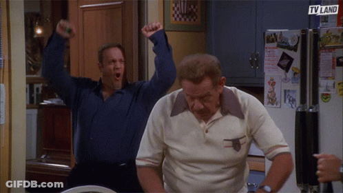 Two Men Are Standing In Front Of A Refrigerator That Says Tv Land On It GIF