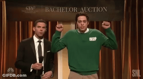 Two Men Are Standing In Front Of A Sign That Says Bachelor Auction GIF