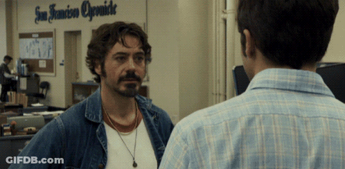Two Men Are Standing In Front Of A Sign That Says San Francisco Opsmide GIF