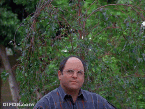 Two Men Are Standing In Front Of A Tree With A Frisbee Flying In The Air GIF
