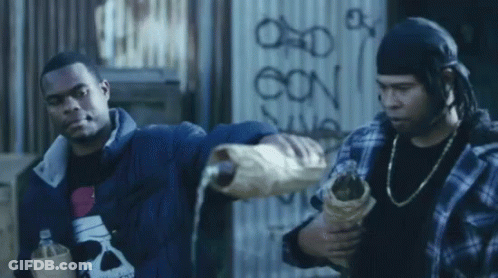Two Men Are Standing In Front Of A Wall That Has The Letters Oon On It GIF