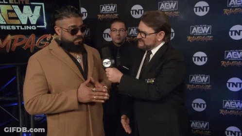 Two Men Are Standing In Front Of A Wall With Aew Wrestling Written On It GIF