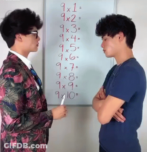 Two Men Are Standing In Front Of A Whiteboard With Numbers On It GIF
