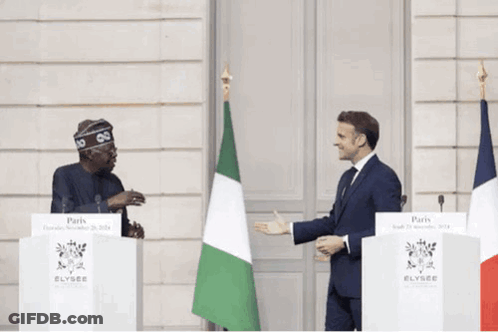 Two Men Are Standing In Front Of Podiums That Say Elysee GIF