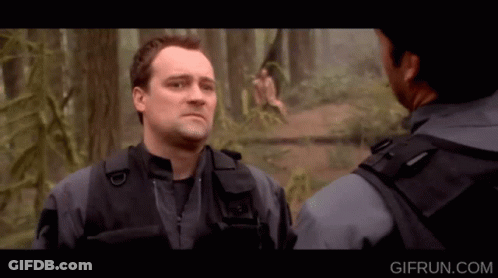 Two Men Standing In Woods Gifrun.com Text GIF