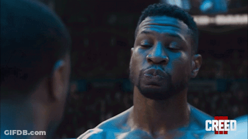 Two Men Are Standing Next To Each Other And Looking At Each Other In A Boxing Ring . GIF