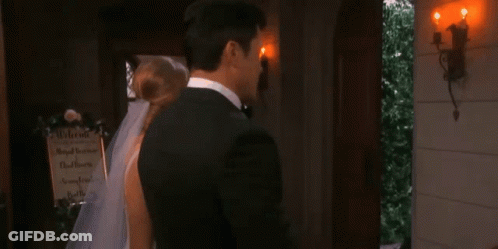 Two Men Are Standing Next To Each Other And Looking At Each Other In A Room . GIF