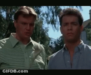 Two Men Are Standing Next To Each Other And Looking At Each Other GIF