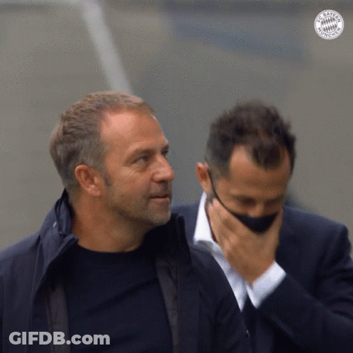 Two Men Are Standing Next To Each Other And One Has A Bayern Munich Logo On His Jacket GIF
