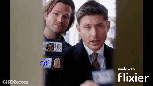 Two Men Are Standing Next To Each Other And One Has A Cbs Badge On His Chest GIF