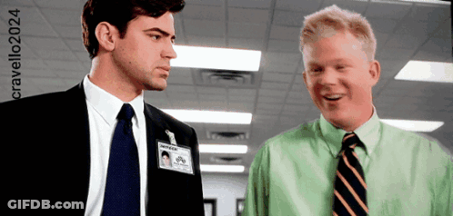 Two Men Are Standing Next To Each Other And One Has A Name Tag That Says Nathan On It GIF