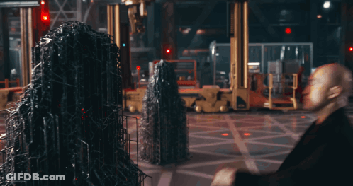 Two Men Are Standing Next To Each Other And One Has A Red Stripe On His Suit GIF