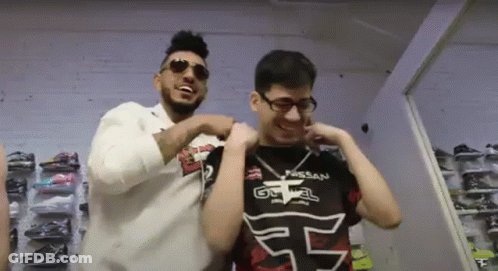Two Men Are Standing Next To Each Other And One Has A Shirt That Says Nissan On It GIF