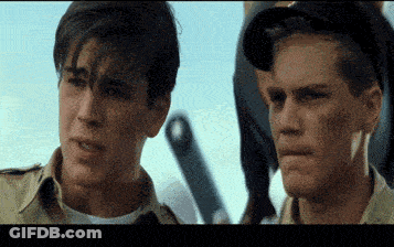 Two Men Are Standing Next To Each Other And One Has A Tooth In His Mouth GIF