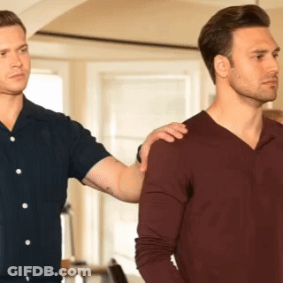 Two Men Are Standing Next To Each Other And One Has His Hand On The Shoulder Of The Other . GIF
