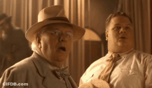 Two Men Are Standing Next To Each Other And One Has His Mouth Open GIF