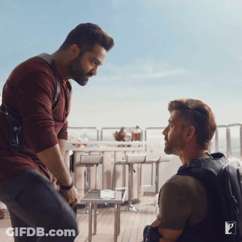Two Men Are Standing Next To Each Other And One Has The Letter Z On His Backpack GIF