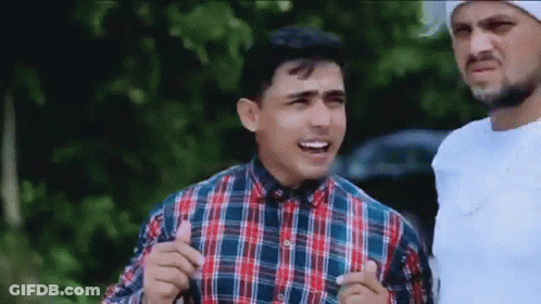 Two Men Standing Next To Each Other GIF
