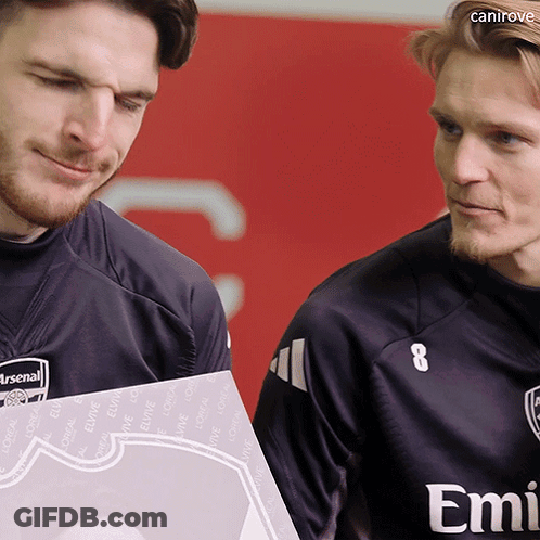 Two Men Are Standing Next To Each Other And One Of Them Has Emirates On His Shirt GIF