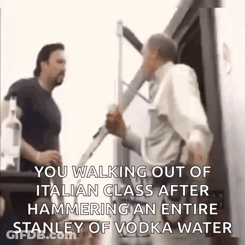 Two Men Are Standing Next To Each Other And One Of Them Is Holding A Bottle Of Vodka . GIF