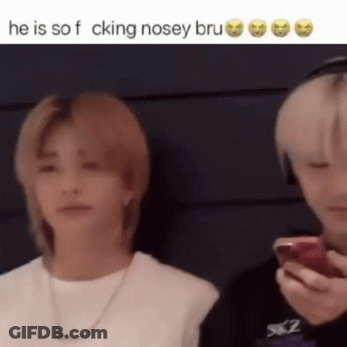 Two Men Are Standing Next To Each Other And One Of Them Is Holding A Cell Phone In His Hand . GIF