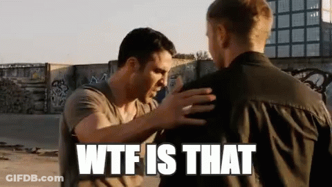 Two Men Are Standing Next To Each Other And One Of Them Is Holding The Other 'S Arm . GIF