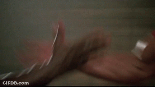 Two Men Are Standing Next To Each Other And One Of Them Is Holding The Other 'S Hand . GIF