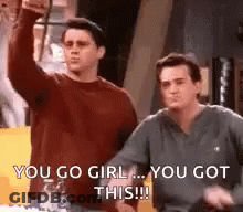 Two Men Are Standing Next To Each Other And One Of Them Is Raising His Fist In The Air . GIF