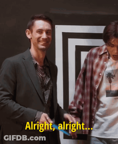 Two Men Are Standing Next To Each Other And One Of Them Is Saying Alright Alright GIF