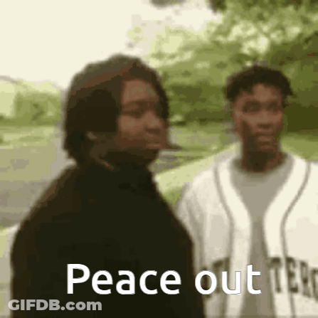 Two Men Are Standing Next To Each Other And One Of Them Is Smoking A Cigarette And The Other Is Smoking A Cigarette . GIF