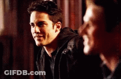 Two Men Are Standing Next To Each Other And One Of Them Is Wearing A Black Jacket GIF
