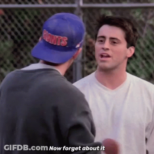 Two Men Are Standing Next To Each Other And One Of Them Is Wearing A Blue Hat That Says Giants . GIF