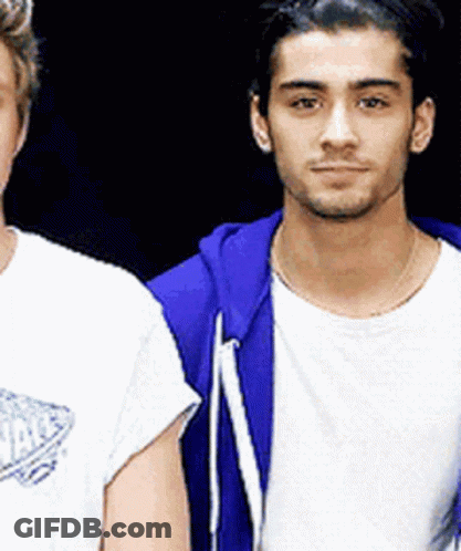 Two Men Are Standing Next To Each Other And One Of Them Is Wearing A Blue Hoodie GIF