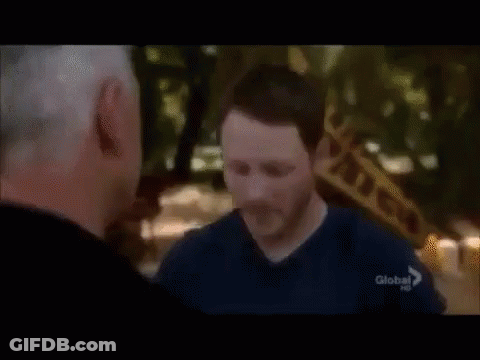 Two Men Are Standing Next To Each Other And One Of Them Is Wearing A Blue Shirt With The Word Global On It . GIF
