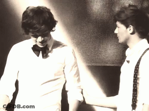 Two Men Are Standing Next To Each Other And One Of Them Is Wearing A Bow Tie GIF