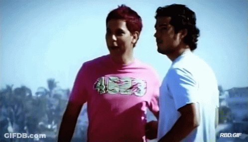Two Men Are Standing Next To Each Other And One Of Them Is Wearing A Pink Shirt That Says ' Rbd.gif ' GIF