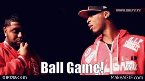 Two Men Are Standing Next To Each Other And One Of Them Is Wearing A Red Jacket That Says Ball Game On It . GIF