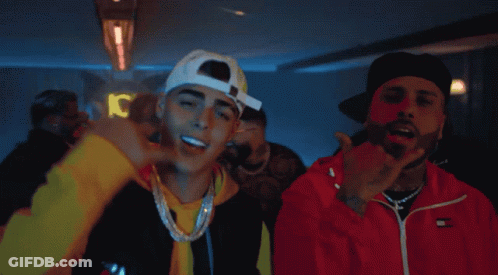 Two Men Are Standing Next To Each Other And One Of Them Is Wearing A Red Tommy Hilfiger Jacket GIF