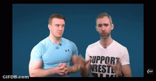 Two Men Are Standing Next To Each Other And One Of Them Is Wearing A Shirt That Says Support Wrestling GIF