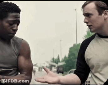 Two Men Are Standing Next To Each Other And One Of Them Is Wearing A Shirt With The Letter H On It GIF