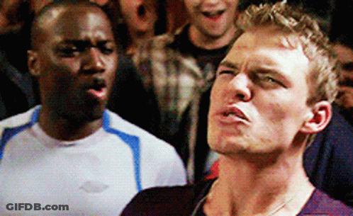 Two Men Are Standing Next To Each Other And One Of Them Is Wearing A Shirt With The Word Chevrolet On It GIF