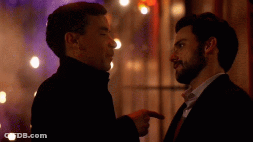 Two Men Are Standing Next To Each Other And Pointing At Each Other GIF