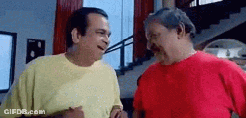 Two Men Are Standing Next To Each Other And Talking In A Living Room . GIF