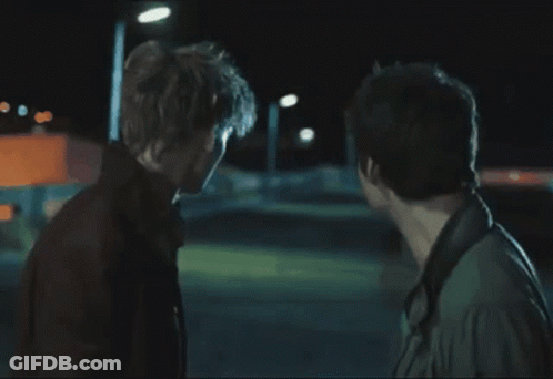 Two Men Are Standing Next To Each Other And Talking GIF